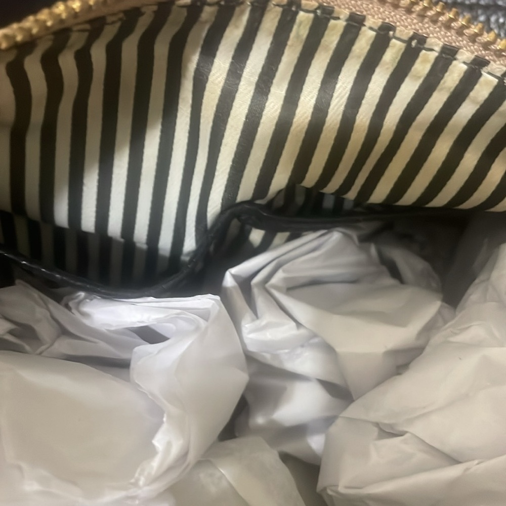 Pre-loved Kate Spade shoulder bag. Colors are fawn and black with gold accents. - Picture 7 of 9